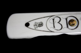 Reel DetailOn the other side of the knife handle is a cartouche with my son’s initials flanked by a tiny image of a saltwater reel on this end and a fishhook at the other end of the cartouche.