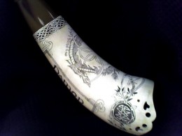 Kirkpatrick Horn View 2 Weeping HeartsThis was a F&I style horn with a tab to attach the strap. I’ve cut weeping hearts into the tab as well as drilled holes for the attachment point. The weeping hearts were of a piece with the spirit of this horn. Around the base of the horn is a band which comes together in a medallion with knotwork in it.