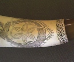 Detail A Celtic ThemeThe client wanted a Celtic theme so I did my best to accomplish that using knotwork for the band around the throat, a Celtic themed cartouche and Celtic lettering.