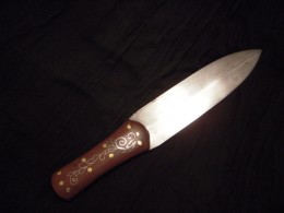 Knife - Wire Inlay The Bennett KnifeI put this knife together with a beavertail dagger blade I had. It has walnut scales and silver wire inlay. I gave it away as the aggregate hawk and knife prize at a rendezvous in 2008.