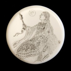 Owl WomanThis image is on the opposite side of the “Pensive Bear “ medallion.  It is of an American Indian woman holding a rattle. Her right arm is an owls wing and she has an owl's face on her chest.