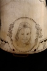 Cameo CameoThere is an oval cameo in the bottom band about 1 1/8 x1 inches. The image is a rendition of the client’s wife taken from a photograph. Her face is framed by her favorite flower: the Lilac.
