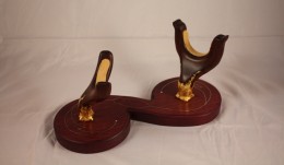 Moler Horn Stand 2 The Moler StandThe base of the stand is purpleheart. The uprights are rosewood. They’re lined with buckskin. The bases are gilded in 24k gold leaf in a freeform design.