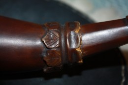 Carving Detail Carving DetailThe rings closer to the engrailing were carved into the shape of leaves, the slightly back cut and finally engraved to emulate leaves. There is a groove where ones’ strap would be tied. At the side closer to the spout I carved the ring to resemble petals and back cut them more than I did on the leaves. I was trying to get the appearance of a flower opening. You also get a glimpse of the “surprise” I put on the horn here.