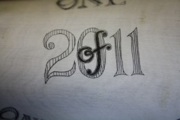 Lettering Detail Lettering DetailI enjoy doing lettering and especially if it represents a little challenge. On the inside curve, flanked by the hunter and his quarry, were the words: “one of one thousand 2011”. The “of” was superimposed on the “2011”. This photo shows some detail of that engraving.