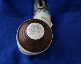 A turned walnut base plug